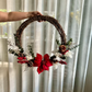 holding a christmas wreath