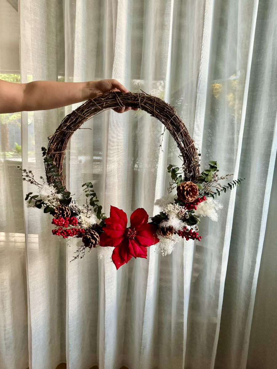 holding a christmas wreath