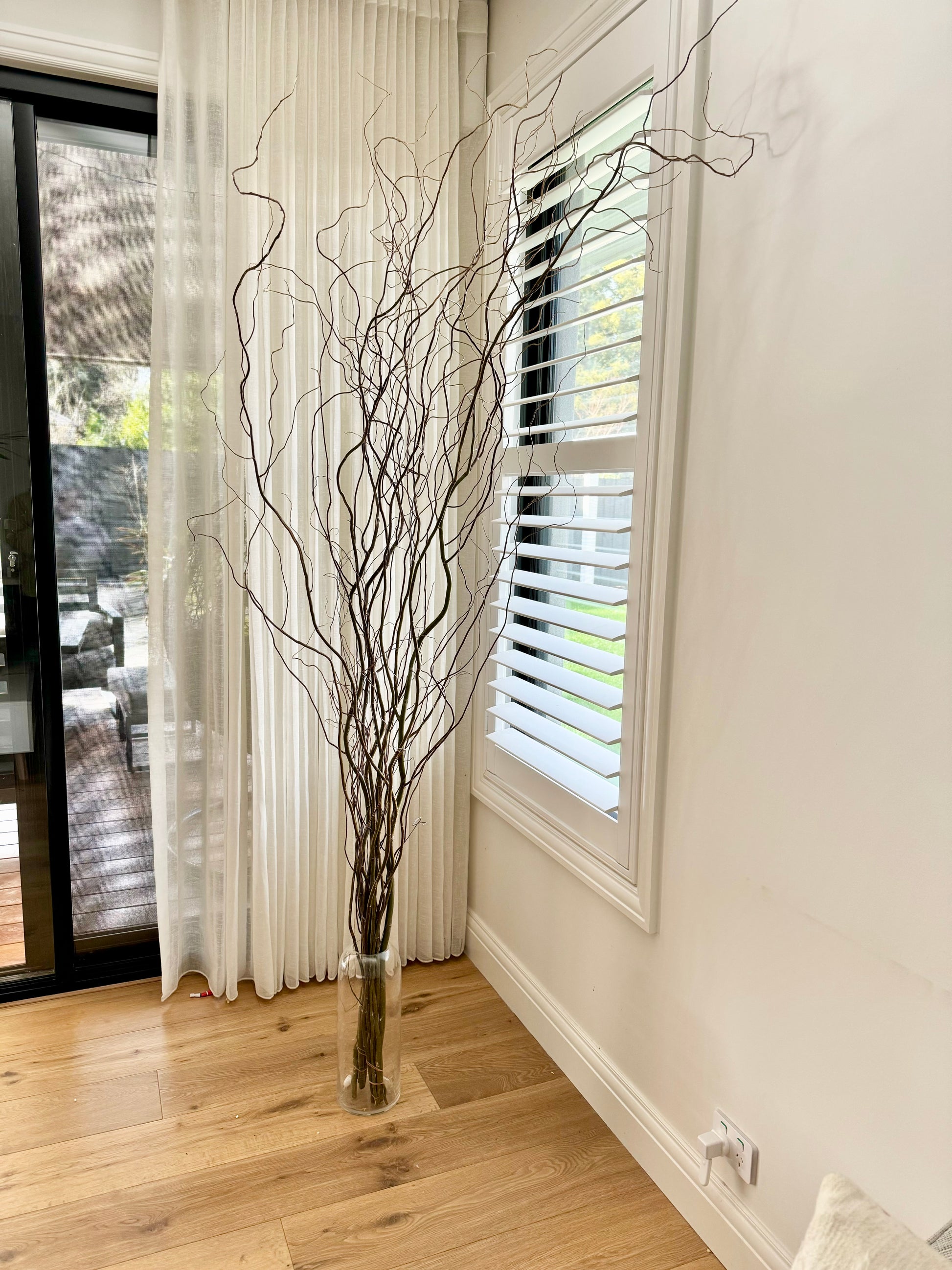 willow tree in a glass floor vase