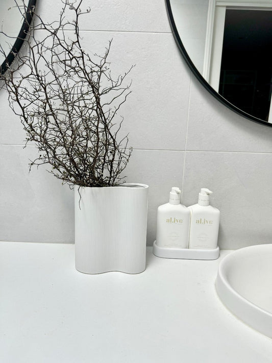 corky in bathroom next to alive hand wash