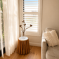 Living room with a couch, small table, and window with blinds