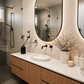 Modern bathroom with wooden vanity, round mirror, and decorative elements.