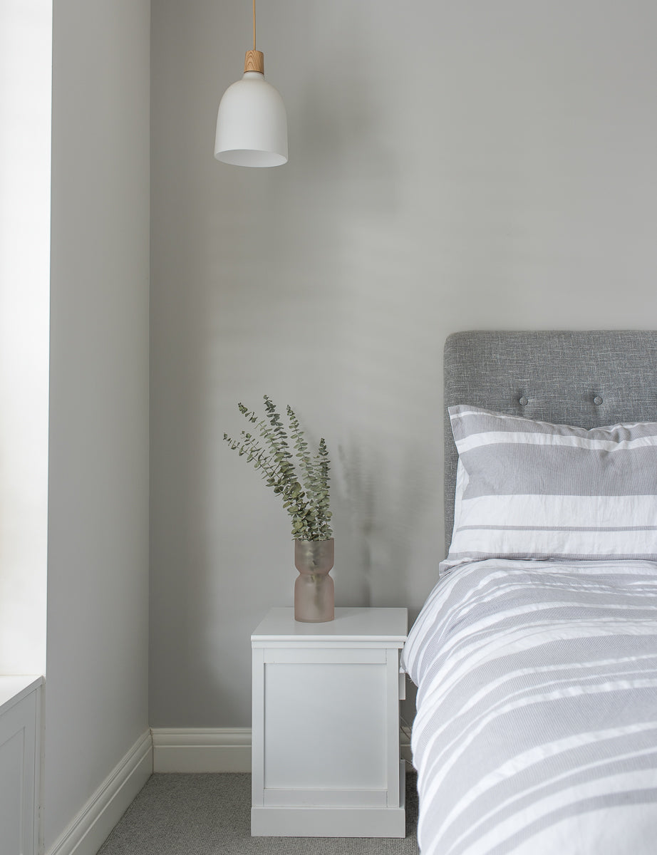 grey bedroom with eucalyptus leaves