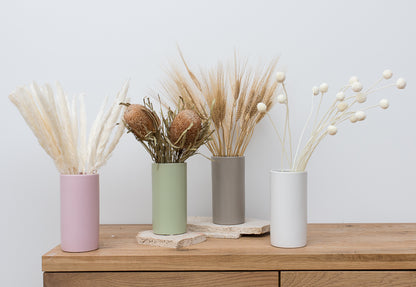 Dried flower stems in vases including wheat, banksia, mini pampas and wheat