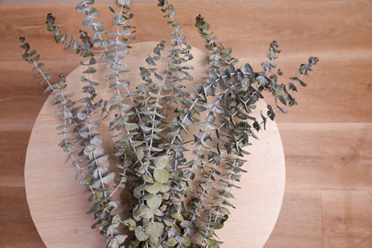 dried eucalyptus on a wooden stool